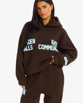 Hidden Hills Gated Community Hoodie Dark Brown/Light Blue, front view with hand at pocket